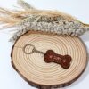 Schlüsselanhänger aus Holz in Form eines Knochens und des Namens des Haustiers